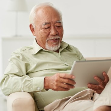 A man reading a tablet.